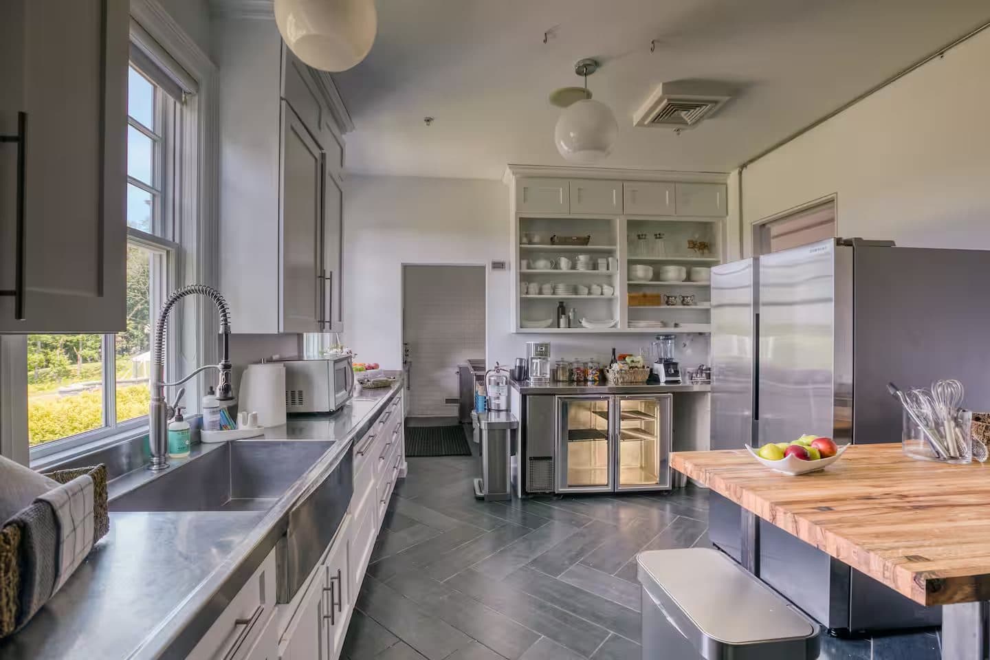 The chef's kitchen with a butcher-block island and herringbone floors