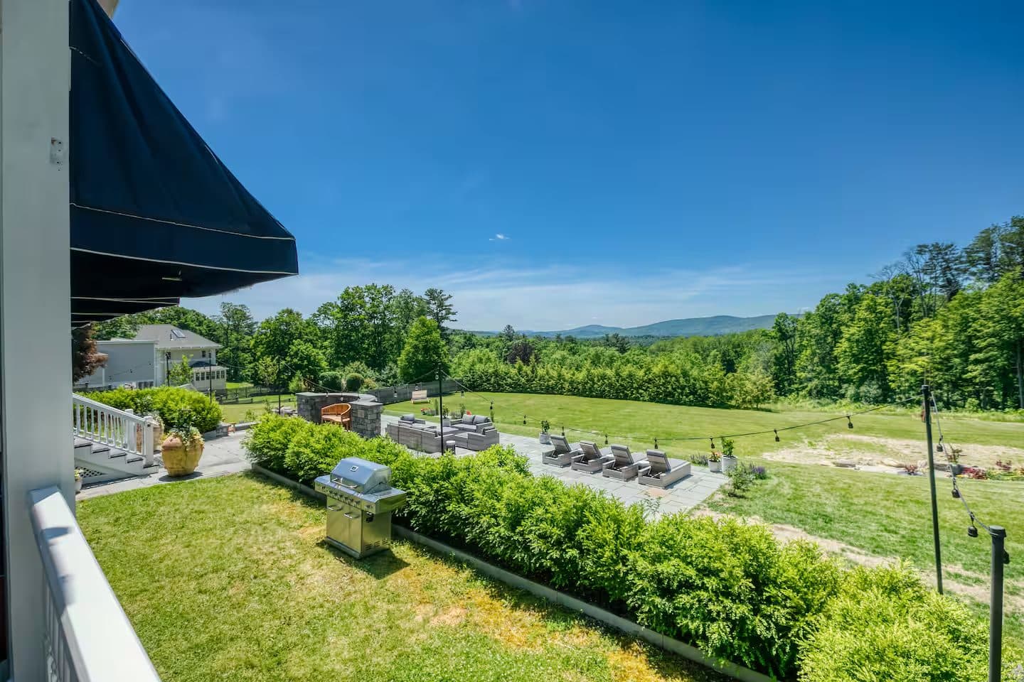 A green lawn rolling toward the misty Berkshire hills